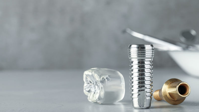 a titanium dental implant post and crown model.